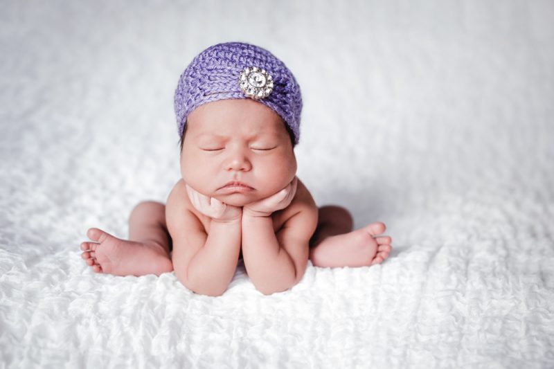 Newborn Baby Girl Wearing a Lavender Flapper Hat